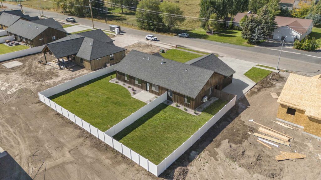 A finished home built by Spring Creek Home Builders. Showing the split yard with the main home and apartment.